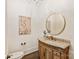 Stylish powder room with a decorative vanity, round mirror, and updated fixtures at 1504 Alydar Ct, Waxhaw, NC 28173