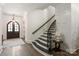 Classic staircase with black handrail and steps, complemented by white walls and wood flooring at 1504 Alydar Ct, Waxhaw, NC 28173