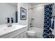 Well-lit bathroom featuring a tub shower with blue patterned shower curtains and a white sink at 153 Jameson Park Dr # 4, Troutman, NC 28166