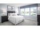 Bright bedroom featuring a large window and two side tables at 153 Jameson Park Dr # 4, Troutman, NC 28166