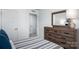 A cozy bedroom featuring a wooden dresser and a view into the ensuite at 153 Jameson Park Dr # 4, Troutman, NC 28166