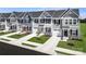 New townhomes feature colorful doors, black shutters, garages, and attractive landscaping at 153 Jameson Park Dr # 4, Troutman, NC 28166