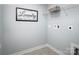 A light and bright laundry room featuring a laundry themed picture on the wall and storage rack at 153 Jameson Park Dr # 4, Troutman, NC 28166
