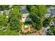 An aerial view of the home surrounded by lush greenery, highlighting the charming two-car garage and landscaped grounds at 1822 Hall Ave, Charlotte, NC 28205