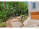Backyard featuring a stepped walkway and colorful flower beds next to a garage at 1822 Hall Ave, Charlotte, NC 28205