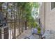 Outdoor balcony with iron railings and chairs overlooking mature trees and landscape at 1822 Hall Ave, Charlotte, NC 28205