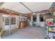 Basement area with open layout, storage shelves, rug, and exposed ceiling beams at 1822 Hall Ave, Charlotte, NC 28205