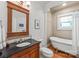 Traditional bathroom with dark wood vanity, clawfoot tub, and stained glass window at 1822 Hall Ave, Charlotte, NC 28205