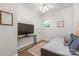 Cozy bedroom with a daybed, ceiling fan, and natural light from a window at 1822 Hall Ave, Charlotte, NC 28205