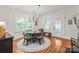 Bright dining room with hardwood floors, elegant chandelier, and plenty of natural light at 1822 Hall Ave, Charlotte, NC 28205