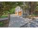A spacious gravel driveway leads to a two-car garage, all secured by an elegant wrought iron gate and fence at 1822 Hall Ave, Charlotte, NC 28205