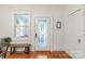 Inviting entryway showcasing a decorative glass door, gleaming hardwood floors, and neutral walls at 1822 Hall Ave, Charlotte, NC 28205