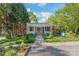 Inviting front exterior featuring a landscaped yard, a cozy porch, and a glimpse of a blue Adirondack chair at 1822 Hall Ave, Charlotte, NC 28205