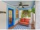 Charming front porch featuring a colorful front door, comfortable seating, and stylish tile at 1822 Hall Ave, Charlotte, NC 28205