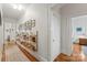 Long hallway with hardwood floors, book shelving, and white walls at 1822 Hall Ave, Charlotte, NC 28205