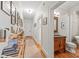 Bright hallway featuring hardwood floors, shelving, and doorway to traditional-style bathroom with freestanding tub at 1822 Hall Ave, Charlotte, NC 28205