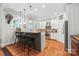 Spacious kitchen with a breakfast bar, granite countertops, and white cabinets at 1822 Hall Ave, Charlotte, NC 28205