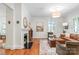 Cozy living room featuring a fireplace, hardwood floors, and seamless access to the dining area at 1822 Hall Ave, Charlotte, NC 28205