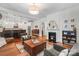 Inviting living room featuring a fireplace, hardwood floors, and open layout to the kitchen at 1822 Hall Ave, Charlotte, NC 28205