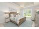 Serene bedroom featuring shiplap walls, a large window, and elegant furnishings at 2008 Waxhaw Crossing Dr, Waxhaw, NC 28205