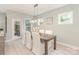 Dining area featuring a wooden table with white chairs and a contemporary light fixture at 2008 Waxhaw Crossing Dr, Waxhaw, NC 28205