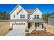Two-story home with a neutral color palette, a two-car garage, and a beautifully landscaped front yard at 2008 Waxhaw Crossing Dr, Waxhaw, NC 28205