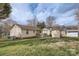Spacious backyard with a well-maintained lawn, fire pit, and storage sheds at 201-A Ewing Dr, Belmont, NC 28012