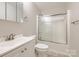 Clean bathroom featuring a shower-tub combo with glass doors and a neutral-colored vanity at 201-A Ewing Dr, Belmont, NC 28012