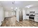 Modern kitchen with stainless steel appliances, white cabinets, and stylish hardwood flooring at 201-A Ewing Dr, Belmont, NC 28012