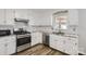 Bright kitchen featuring stainless steel appliances, granite countertops, and a stylish backsplash at 201-A Ewing Dr, Belmont, NC 28012