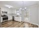 Efficient kitchen layout with stainless appliances, white cabinets, and access to outdoor deck at 201-A Ewing Dr, Belmont, NC 28012