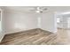 Spacious living room with hardwood floors, a ceiling fan, and neutral paint, creating a cozy atmosphere at 201-A Ewing Dr, Belmont, NC 28012