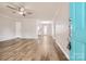 Bright, open-concept living room featuring hardwood floors, ceiling fan, and modern decor at 201-A Ewing Dr, Belmont, NC 28012