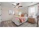 Cozy bedroom featuring a ceiling fan, patterned wall, and stylish decor at 2010 Puddle Pond Rd, Indian Trail, NC 28079