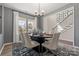Elegant dining area features a modern chandelier, neutral decor, and a staircase in the background at 2010 Puddle Pond Rd, Indian Trail, NC 28079