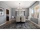 Contemporary dining room features a modern chandelier, a mirrored wall, and a stylish rug under the dining table at 2010 Puddle Pond Rd, Indian Trail, NC 28079