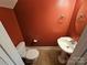 Compact half bathroom with sink and toilet features striking red walls and tiled flooring at 2026 Talbot Ln, Hickory, NC 28602