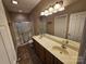 Bathroom showcasing double sinks, a large mirror, and a glass enclosed shower at 2026 Talbot Ln, Hickory, NC 28602