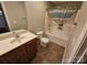 Well-lit bathroom featuring a vanity, toilet, and bathtub with shower curtain at 2026 Talbot Ln, Hickory, NC 28602