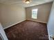 Neutrally decorated bedroom with a window allowing natural light at 2026 Talbot Ln, Hickory, NC 28602