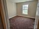 Bedroom with neutral walls, carpet and a large window at 2026 Talbot Ln, Hickory, NC 28602