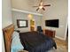 Primary bedroom featuring a large bed, ceiling fan, TV and an ensuite bathroom at 2026 Talbot Ln, Hickory, NC 28602