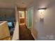 Hallway with beige walls, brown carpet, and doors leading to various rooms at 2026 Talbot Ln, Hickory, NC 28602