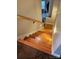 Wooden staircase with white risers and a wooden handrail leads to the upper level at 2026 Talbot Ln, Hickory, NC 28602