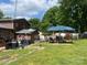 View of the backyard featuring a covered patio and a well-maintained lawn at 204 Aspen Dr, Gastonia, NC 28052