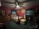 Cozy bedroom with dark green carpet, a queen size bed and lots of wall decor at 204 Aspen Dr, Gastonia, NC 28052