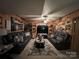 Spacious wood-paneled living room with plush leather sofas, a large TV, and a cozy rug at 204 Aspen Dr, Gastonia, NC 28052