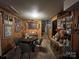 Living room with wood-paneled walls, and dark wood table with four chairs at 204 Aspen Dr, Gastonia, NC 28052