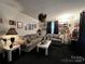 Cozy living room with sofas, area rug, and dark curtains creating a moody atmosphere at 204 Aspen Dr, Gastonia, NC 28052