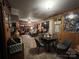 Living room with wood-paneled walls, and brick fireplace at 204 Aspen Dr, Gastonia, NC 28052